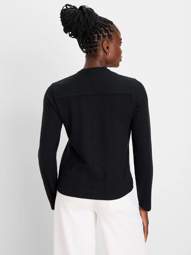 Black long-sleeve top with a subtle cable knit texture, shown from the back.