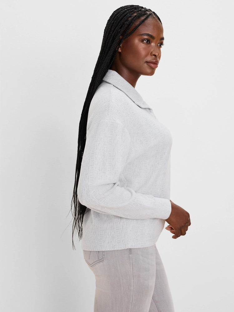 Light gray cable knit pullover top with a collar and long sleeves.