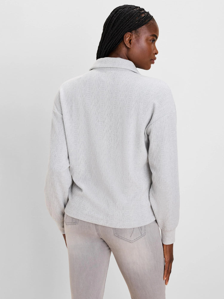 Light grey cable knit pullover with a stand-up collar.