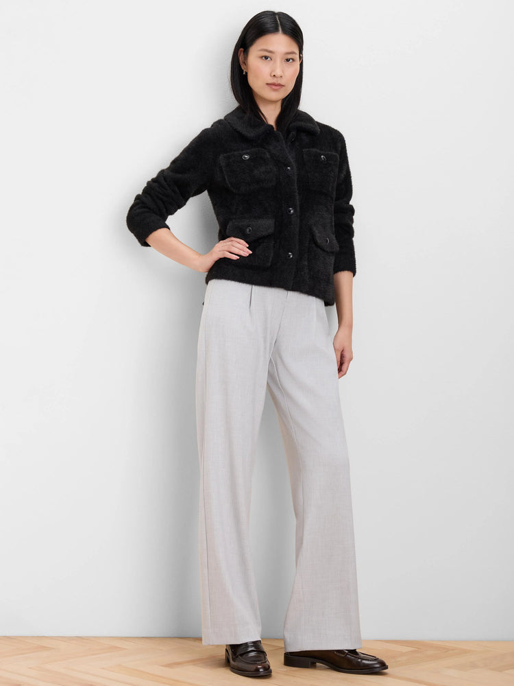 Black fuzzy jacket with a collar, front buttons, and four patch pockets.