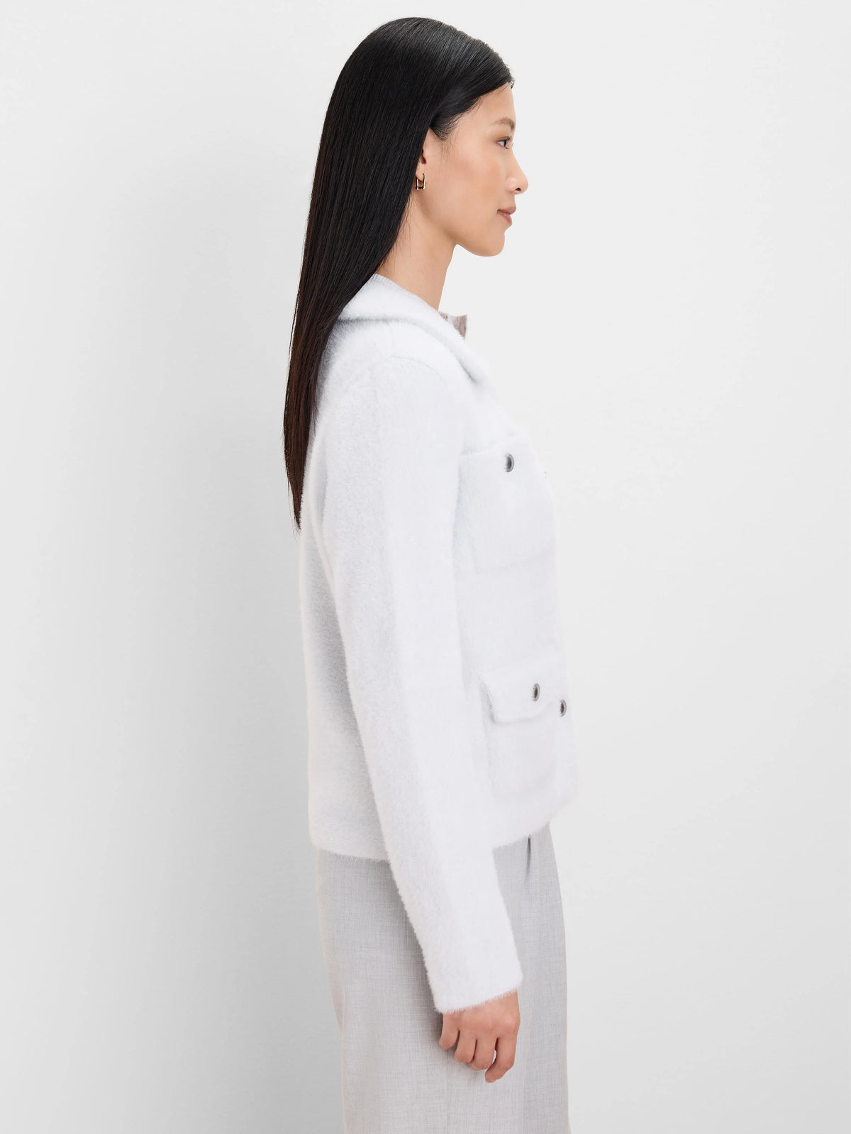 Light blue fuzzy collared jacket with two chest patch pockets featuring silver hardware.