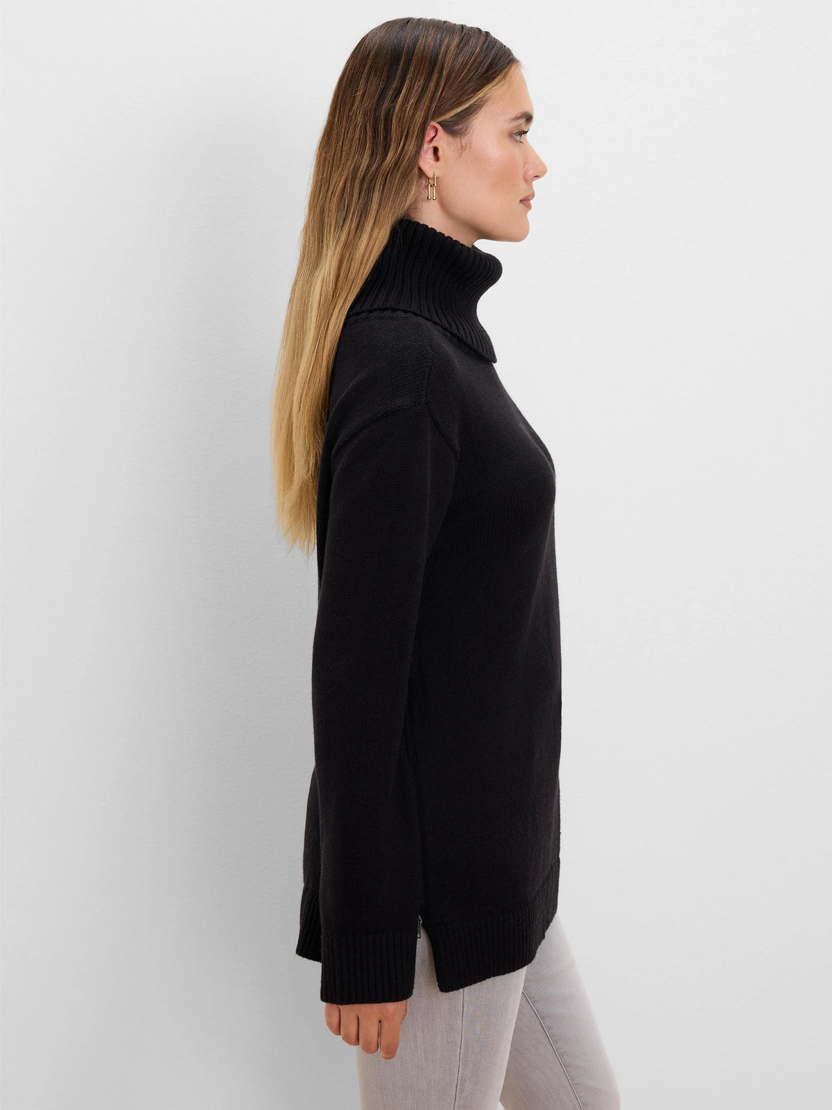 Black long-sleeve sweater with foldover turtleneck, ribbed cuffs, and a side zipper near the hem.