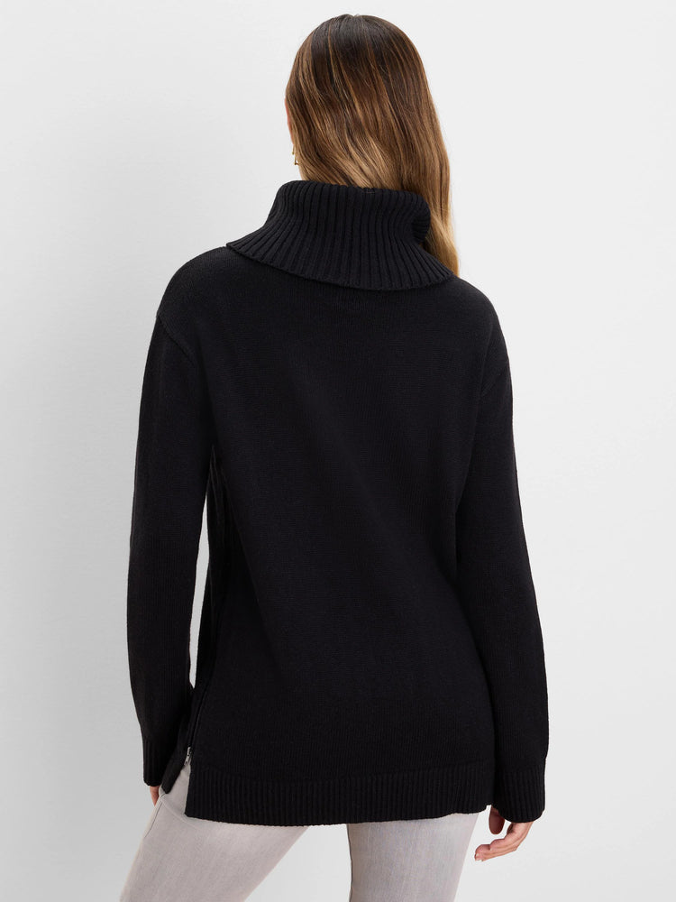 Black foldover turtleneck sweater, back view. Features ribbed cuffs, hem, and a silver side zipper.