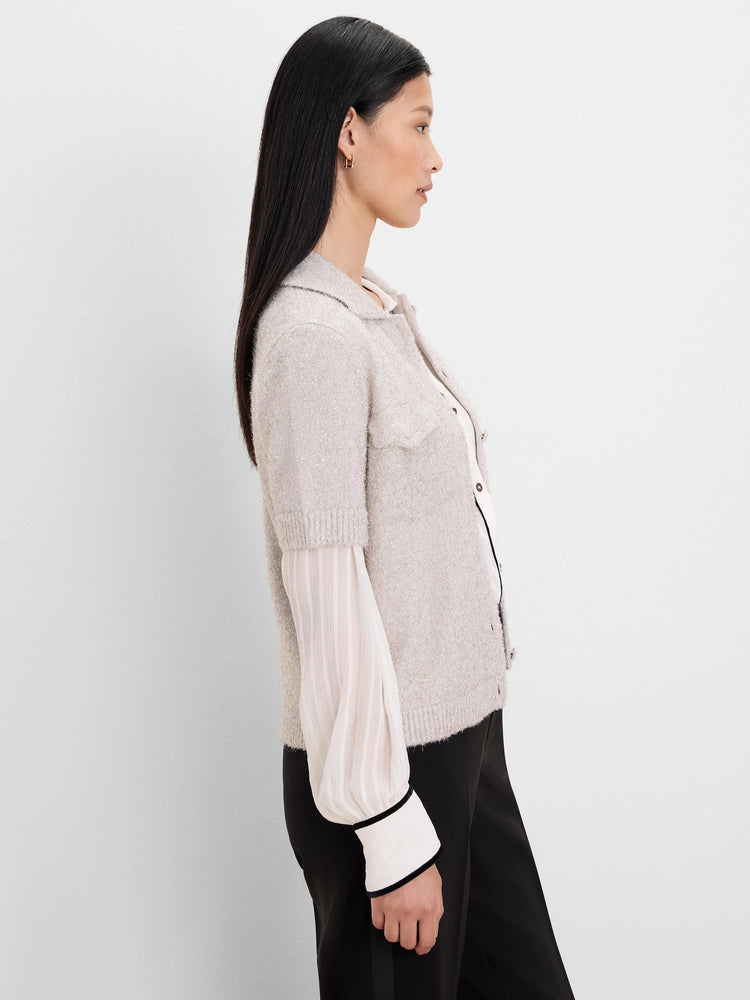 Heathered light beige collared cardigan with short sleeves, front buttons, two chest pockets, and subtle shimmer.