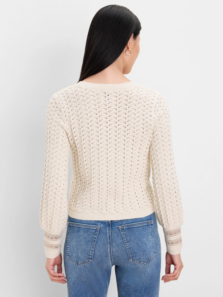 Ecru knit cardigan, back view. Features all-over filigree open-knit pattern & decorative cuffs.