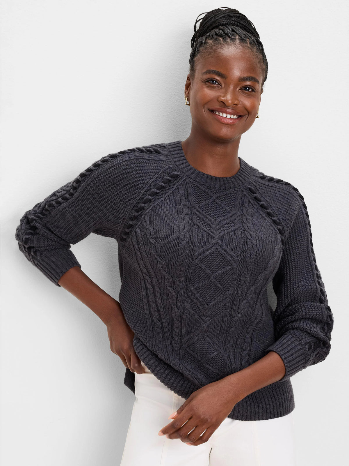 Dark gray patchwork cable knit sweater, featuring varied cable patterns on the body and sleeves.
