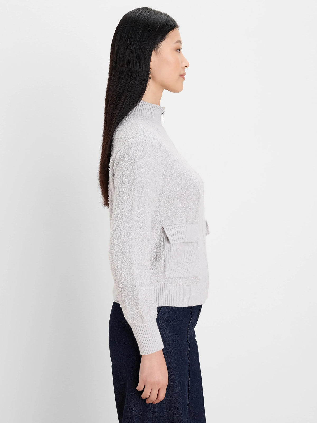 Light grey loopy knit jacket with mock neck, half-zip, and ribbed patch pocket.