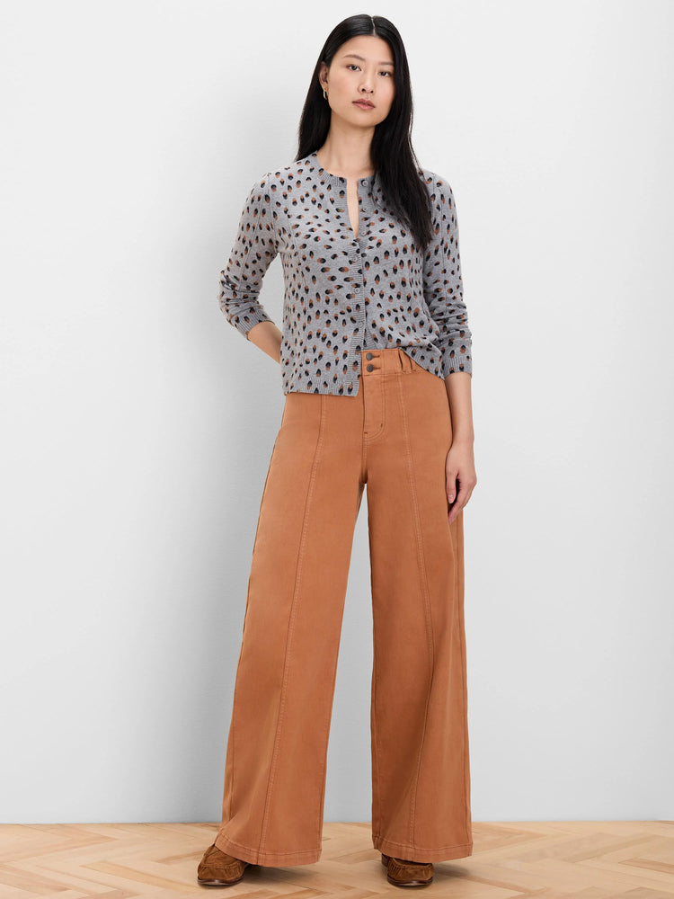 Grey button-front cardigan with irregular brown and black dot pattern. Long sleeves.