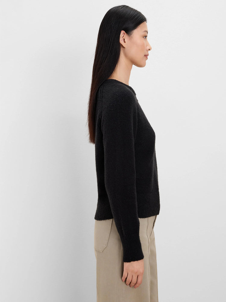 Dark grey fuzzy knit sweater with a crew neck, long sleeves, and ribbed cuffs.
