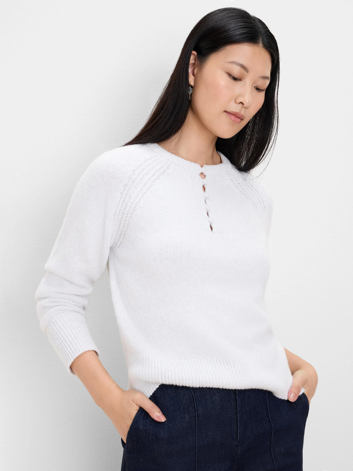 White sweater with round neck, 5-button Henley placket, textured knit shoulders, ribbed cuffs & hem.