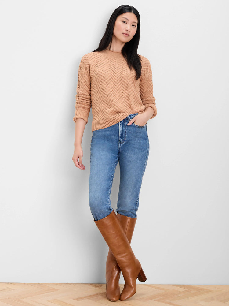 Tan roll neck sweater with a distinct zigzag weave pattern.