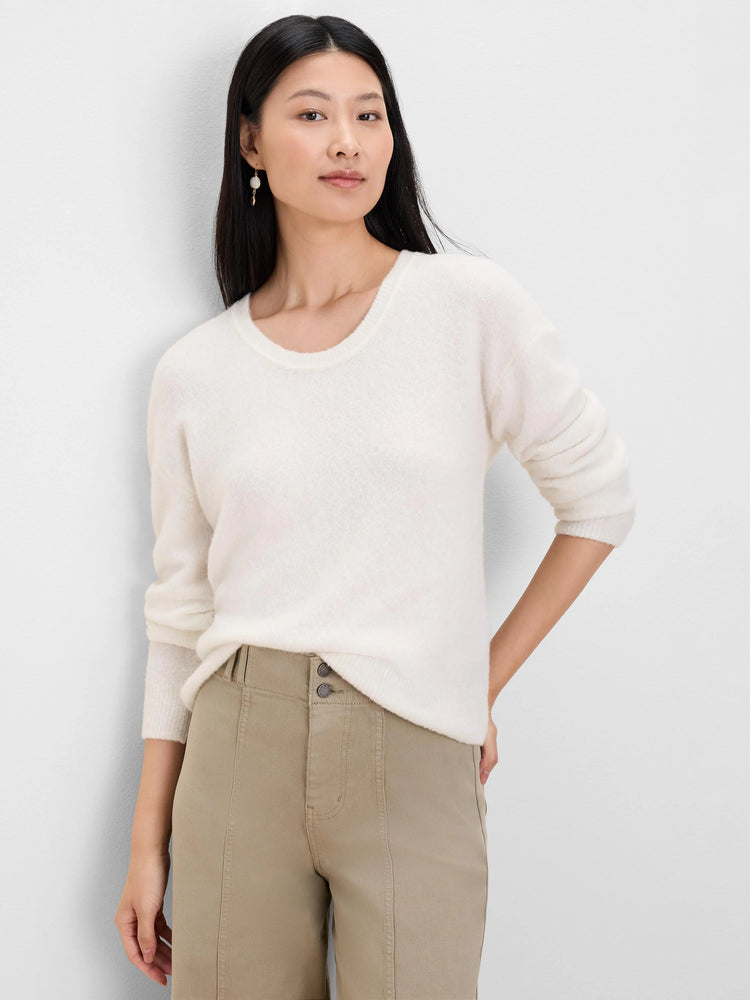 Creamy white slouchy scoop neck sweater with long sleeves and a fuzzy texture.