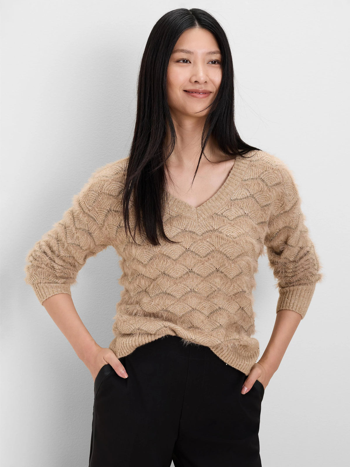 Beige V-neck sweater with fuzzy texture, gold shimmer, and scallop knit pattern.