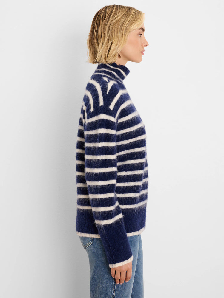Navy and off-white striped turtleneck sweater with a brushed, fuzzy texture.