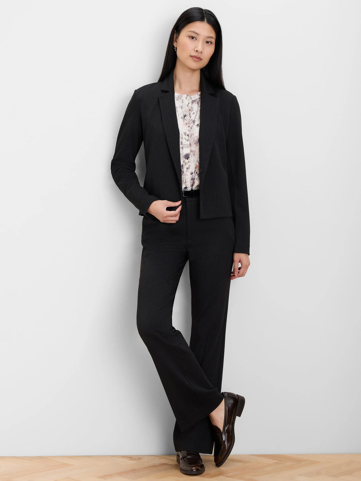 Black boot-cut pants with fine white pinstripes.