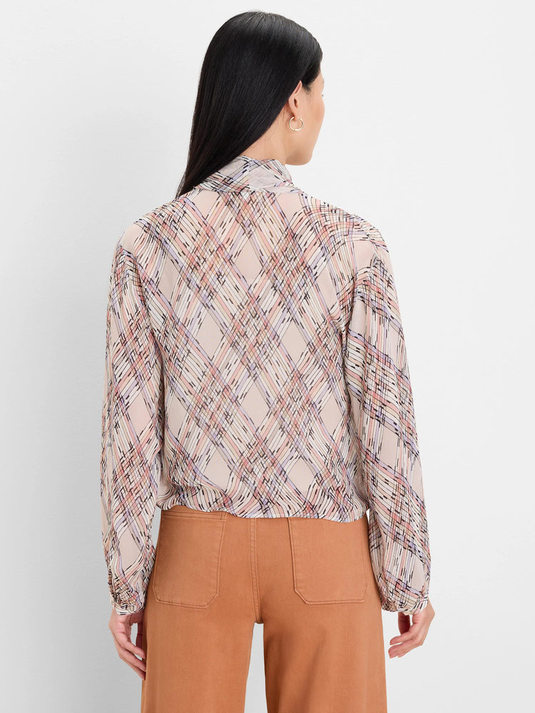 Back of beige tie-neck shirt with painted plaid pattern in pink, lavender, peach, and black lines. Elasticated waist and...
