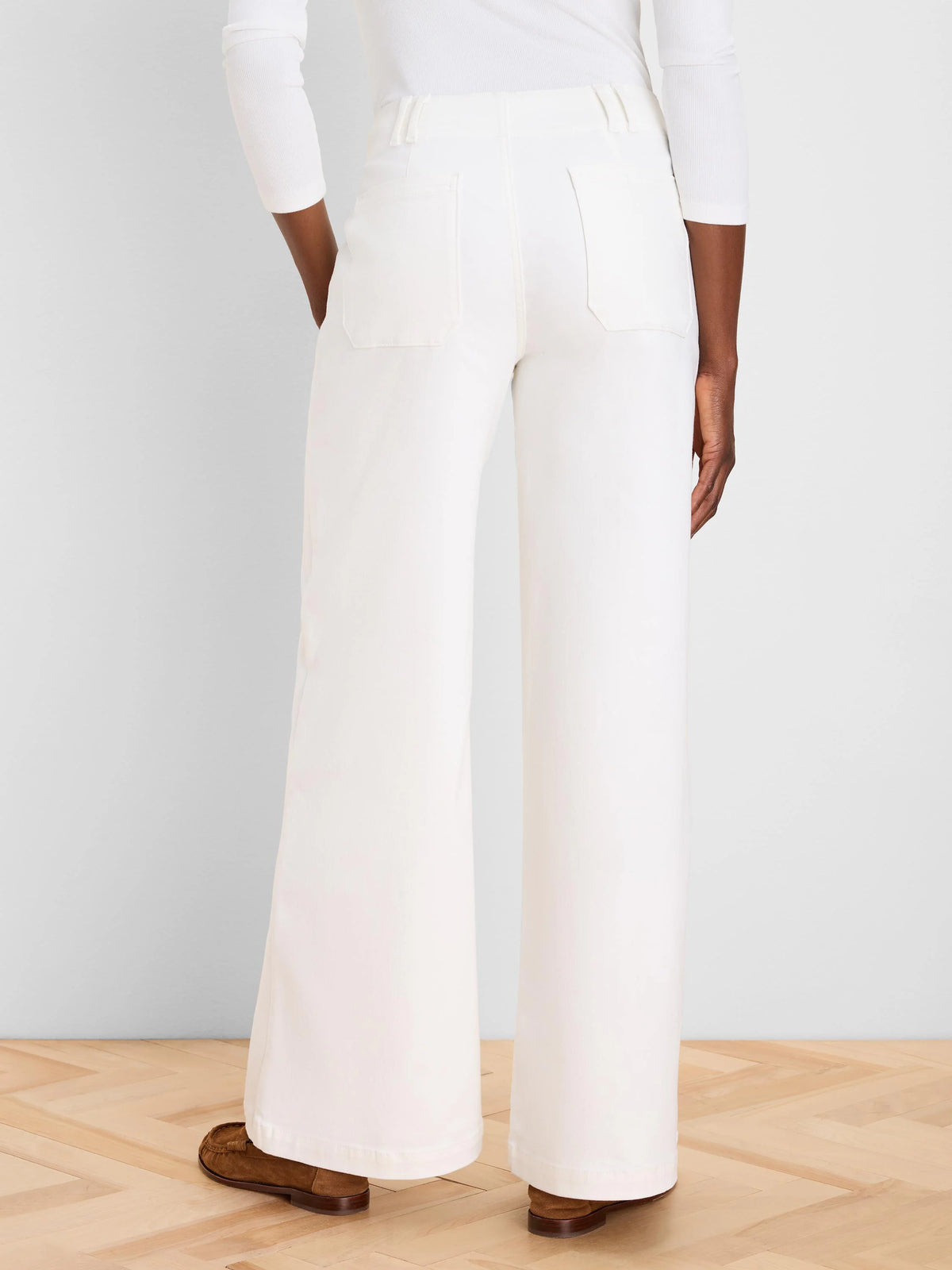 Off-white wide leg jeans, back view on model, showing flat patch pockets, belt loops, and full-length cut.