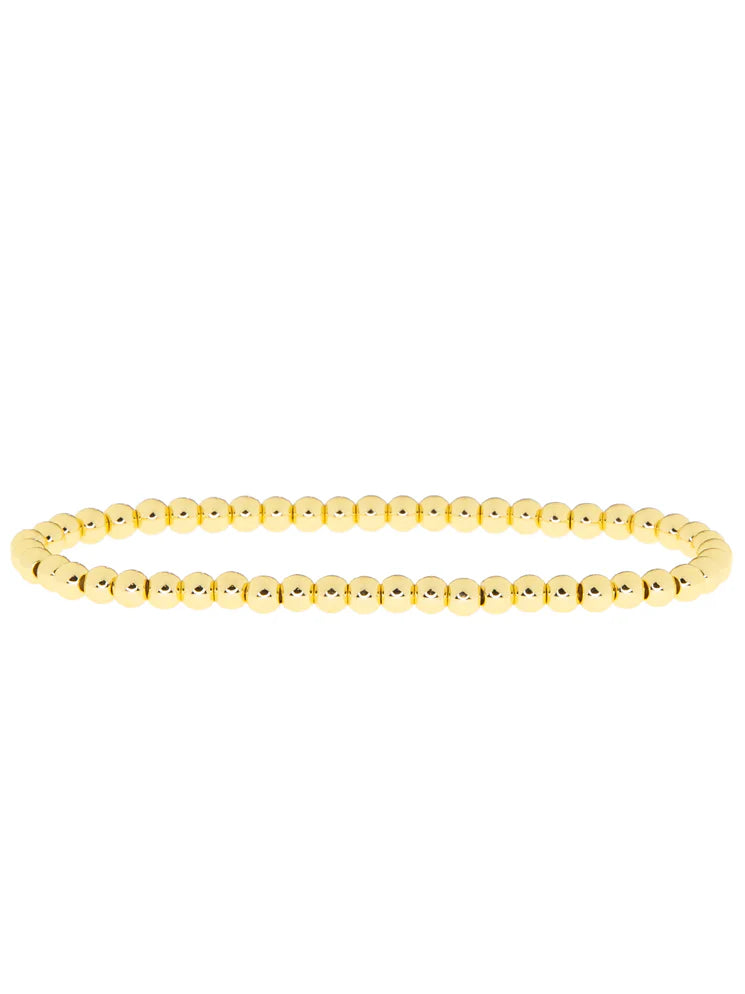 A single strand bracelet of small, round, lustrous gold beads.