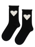 A pair of black crew socks, each with a white heart design near the cuff.