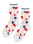 White crew socks display a playful pattern of red, navy, and beige hearts, accented by a narrow navy cuff.