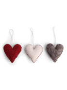 A set of three felt heart ornaments in red, white, and gray, detailed with contrast stitching and hanging loops.