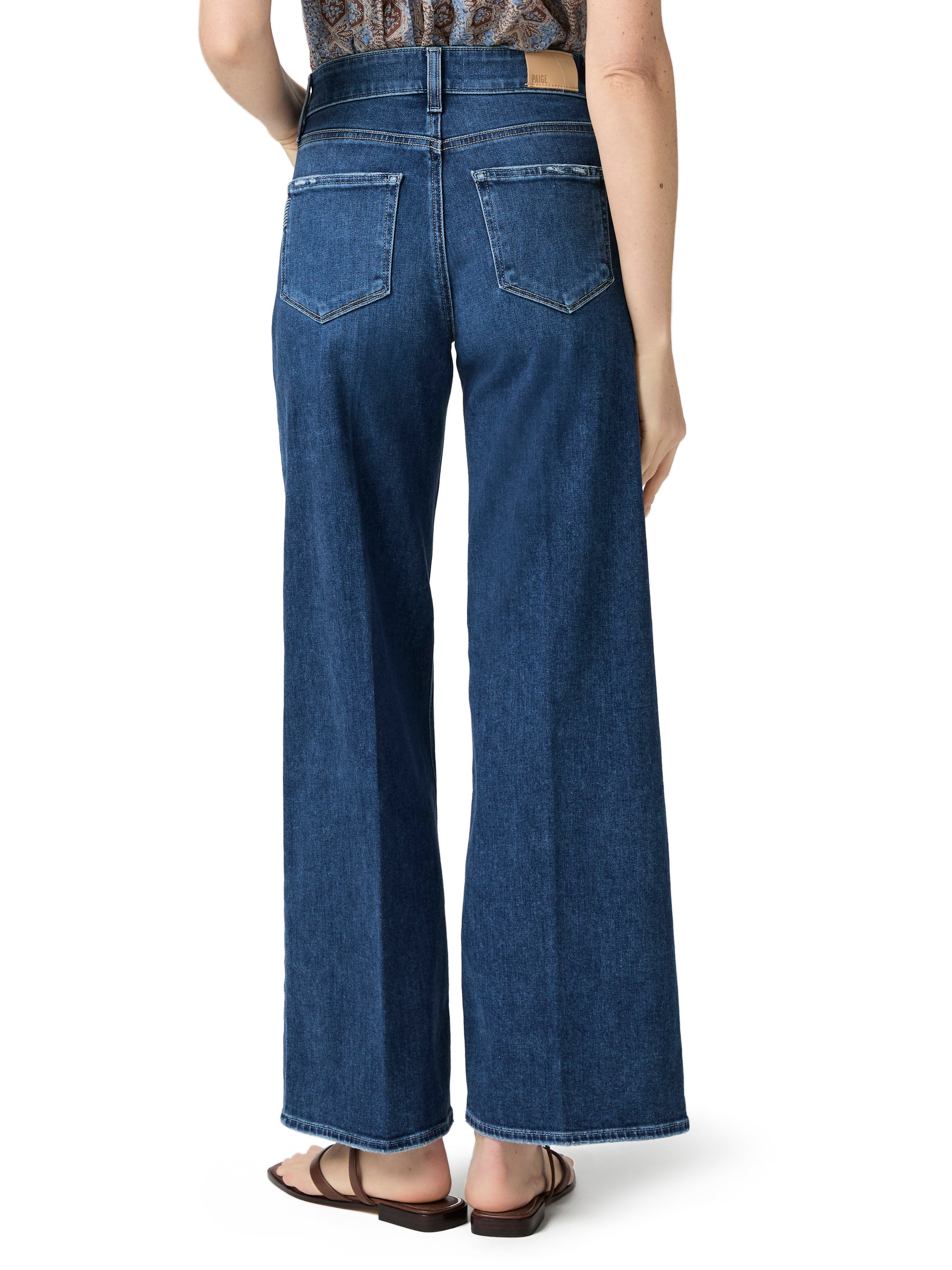 Dark wash denim wide-leg jeans feature a high-rise waist and traditional back pockets.