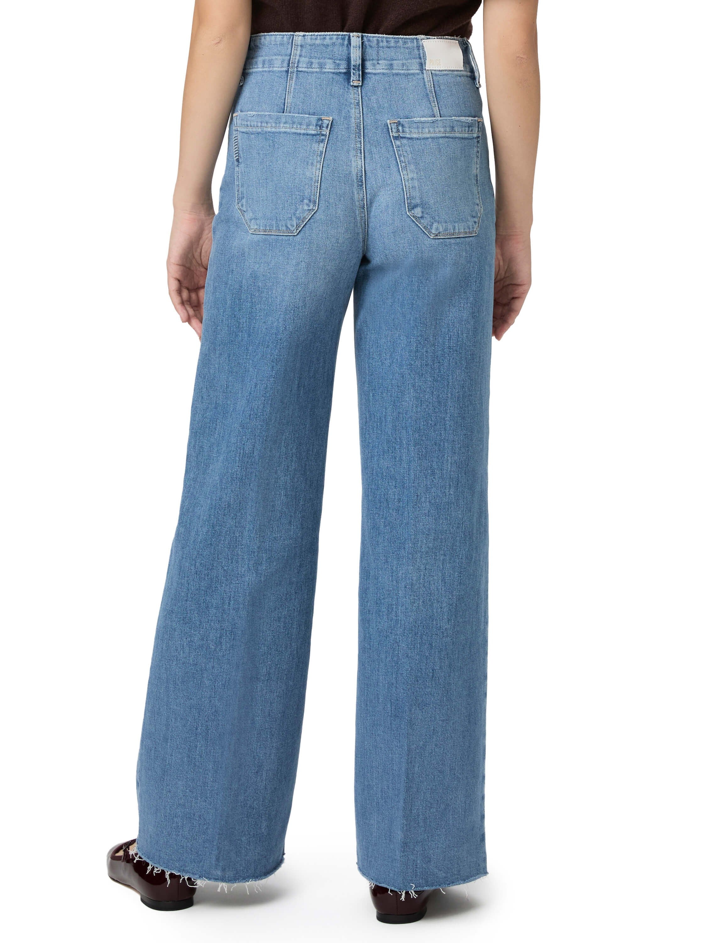 Here's alt text for the image, under 125 characters:

"Rear view of light blue, wide-leg jeans with frayed hems and back...