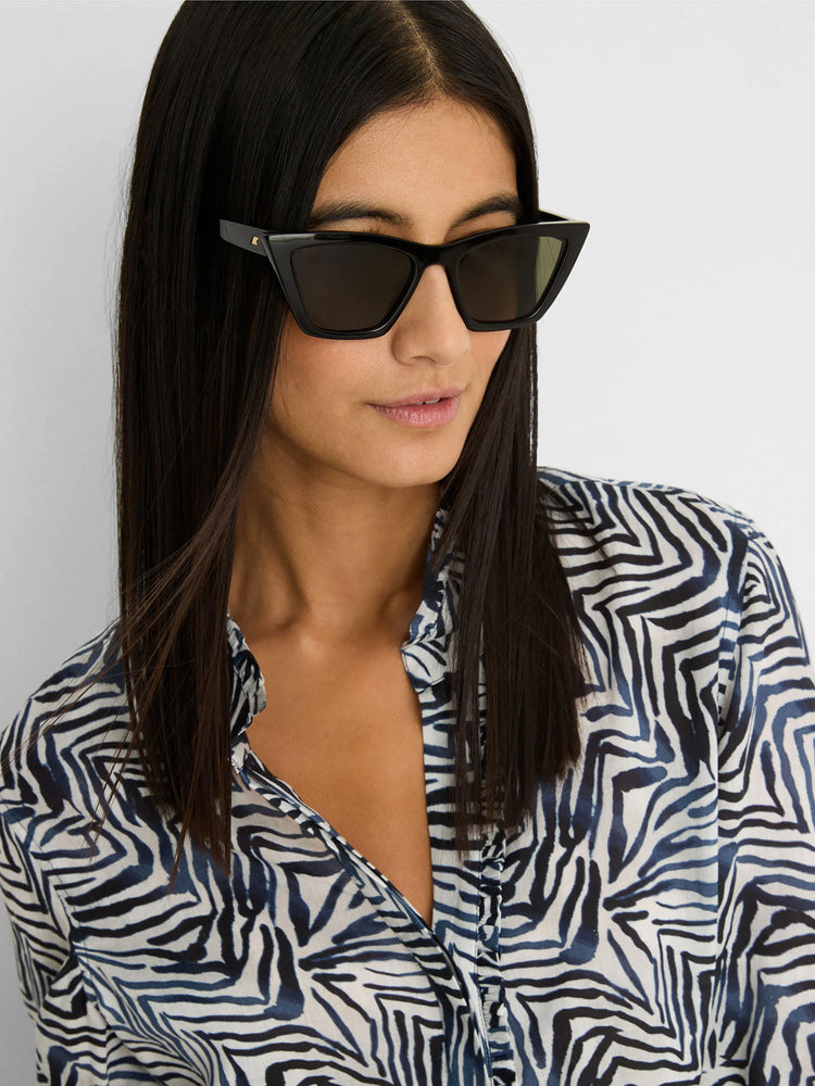 Black angular cat-eye sunglasses with dark lenses and a small gold detail on the temple.
