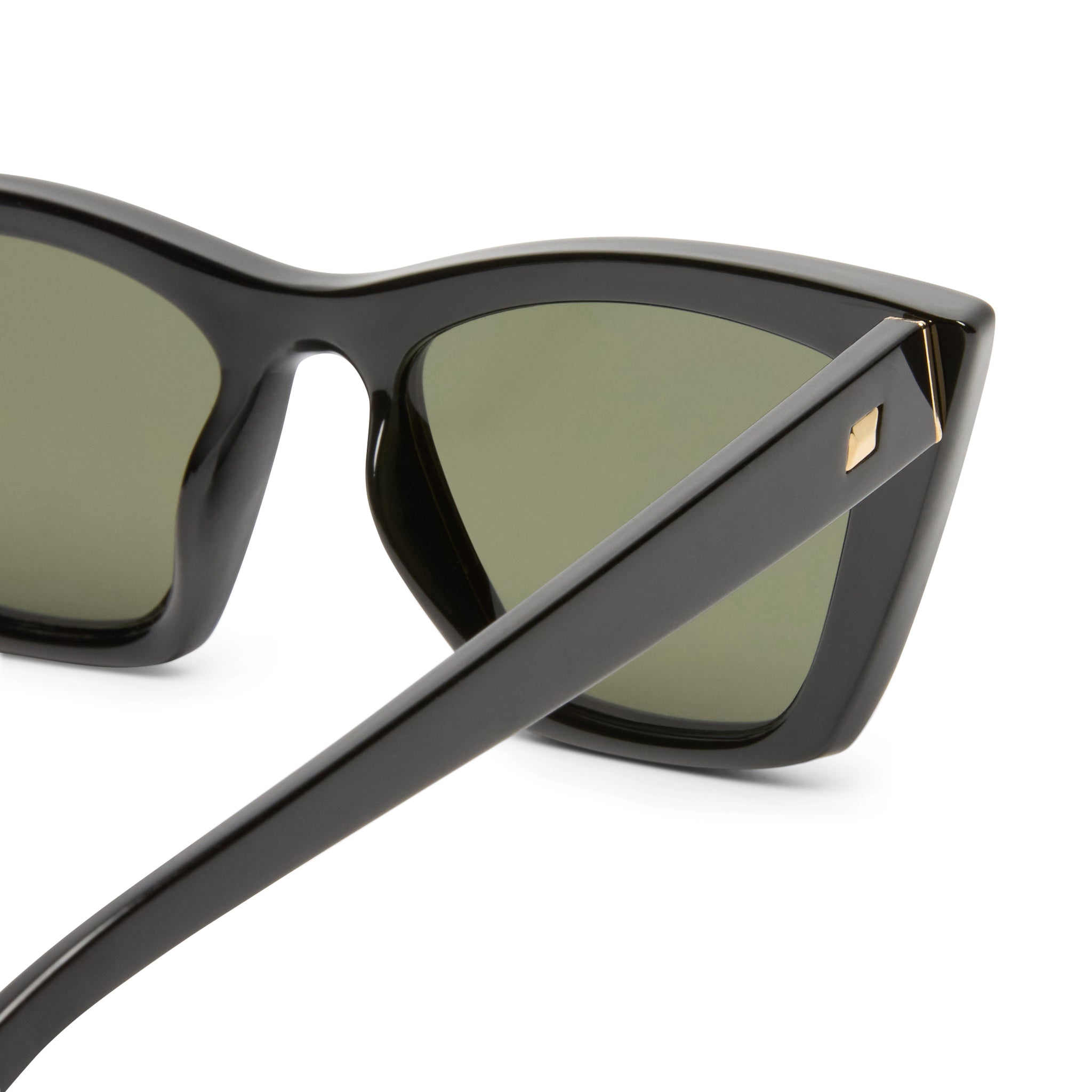 These black sunglasses feature thick frames with dark green lenses and a signature gold stud detail on the temple arm.