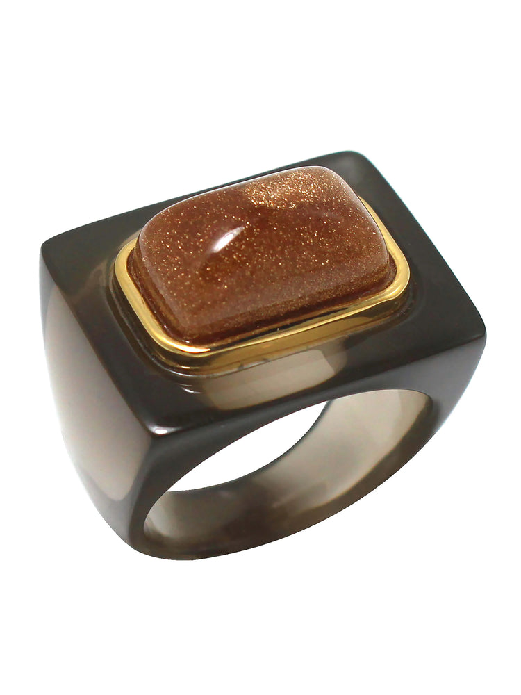 Smoky grey block ring with a gold-framed, rectangular, domed gold-brown glitter stone.
