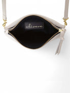 Light gray crossbody bag with gold zipper and hardware, black interior. Shoulder strap.