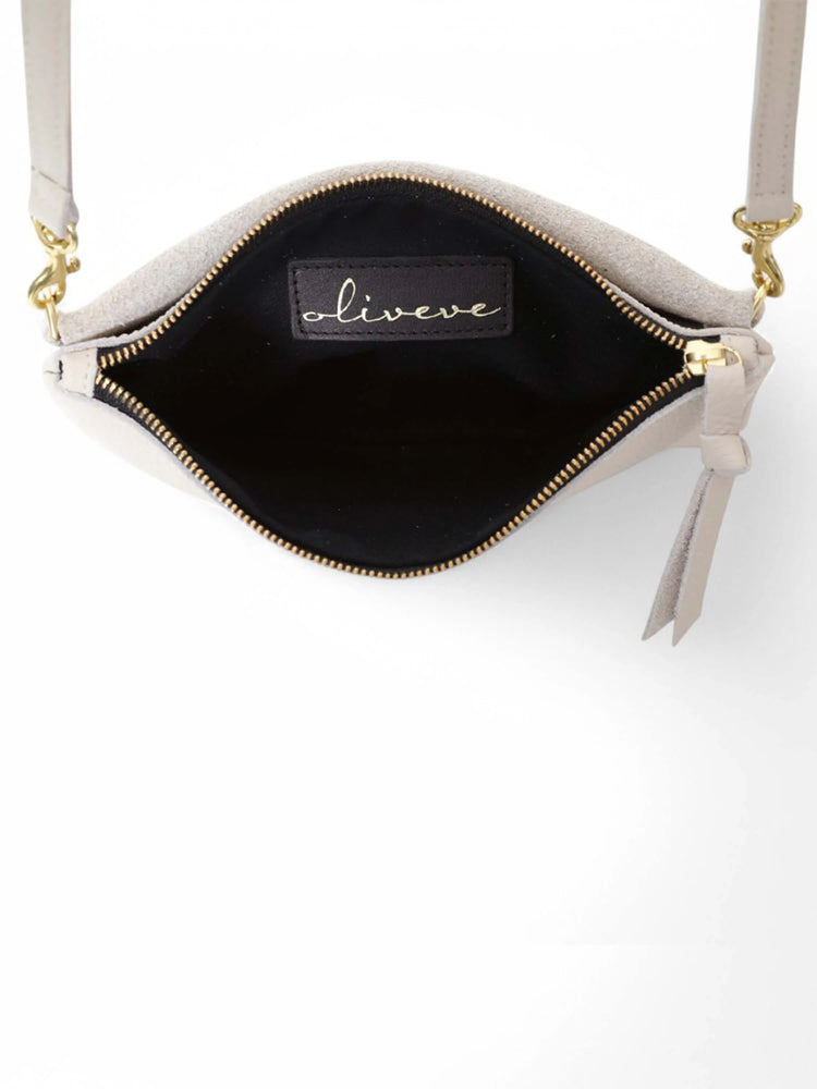 Light gray crossbody bag with gold zipper and hardware, black interior. Shoulder strap.