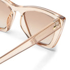 Le Specs Velorome sunglasses: translucent peach frames, gradient brown lenses, gold hinge.