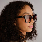 These oversized square sunglasses in dark tortoiseshell feature brown gradient lenses and gold temple accents.