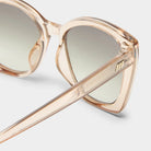 These oversized sunglasses feature translucent champagne frames, gradient lenses, and a gold-tone temple detail.