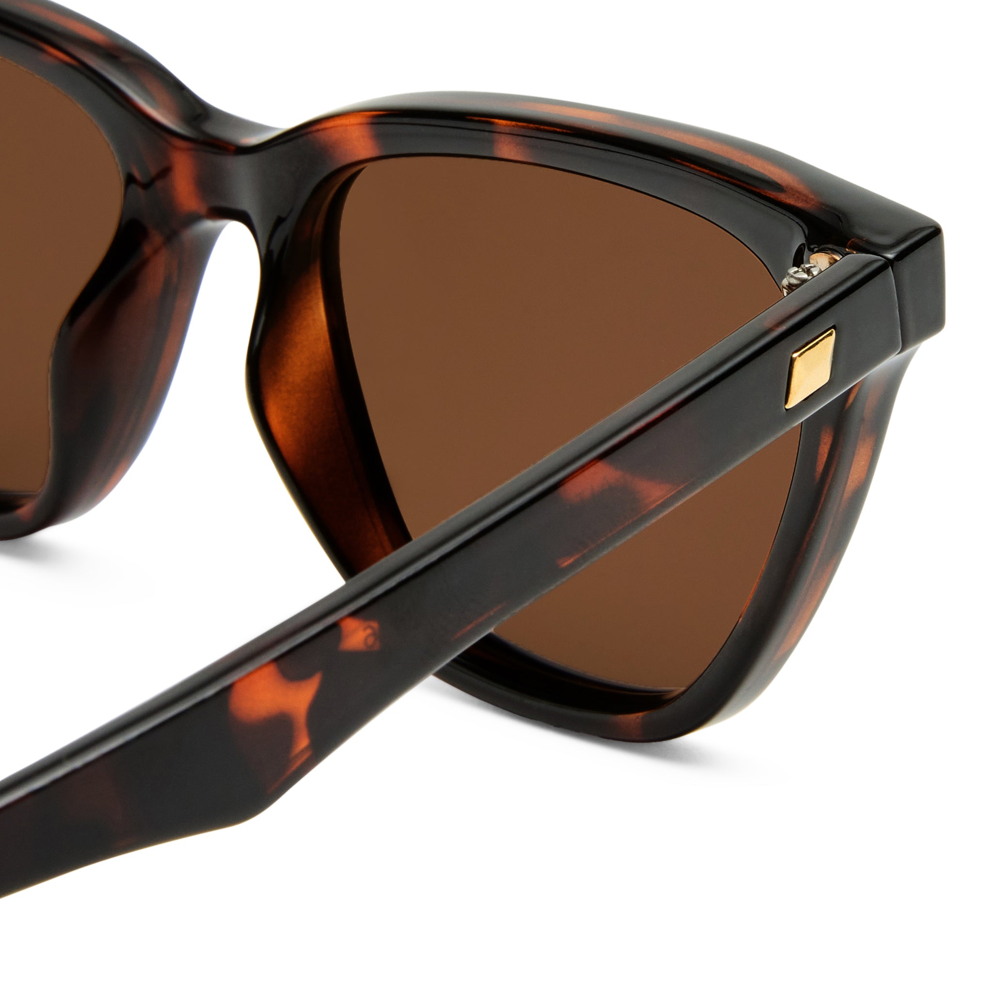 Tortoiseshell cat eye sunglasses feature brown lenses and gold square details on the temples for a chic flattering fit.