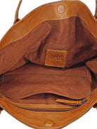 Brown leather tote bag, tan interior lining, zippered pocket, small leather brand label.