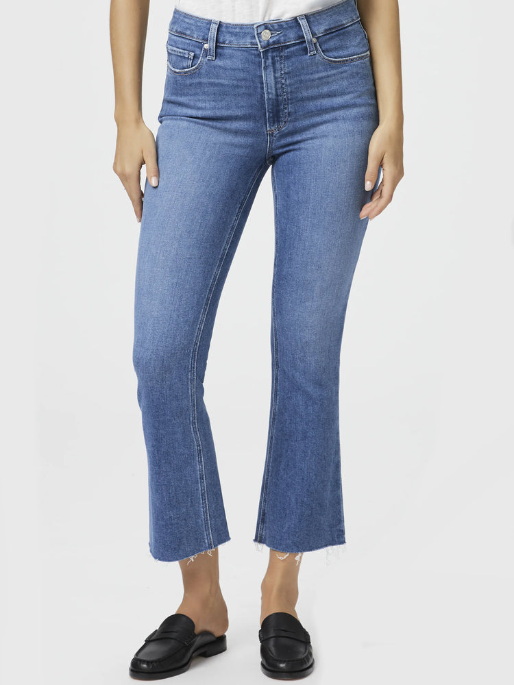 Here's alt text under 125 characters:

Mid-wash blue cropped flare jeans, raw hem.  Model wears black loafers.