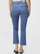 Here's alt text under 125 characters:

Mid-rise, cropped blue jeans, flared legs with raw hem.  Back view.