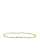 Gold beaded bracelet with three central sparkling crystal beads.