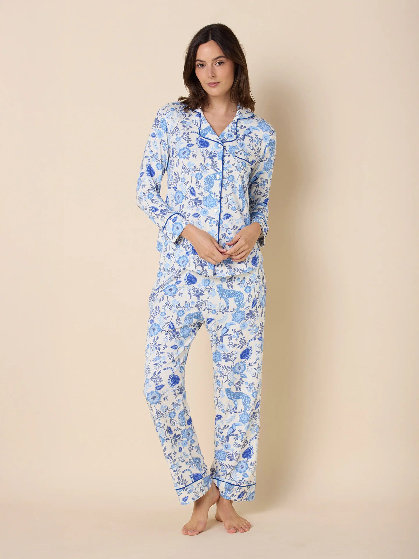 White long-sleeve pajama set with blue floral, leopard, and bird patterns. Blue piping trim.
