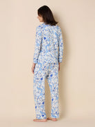 White long-sleeve pajama set with a blue floral, jaguar, and bird pattern, piped in dark blue.
