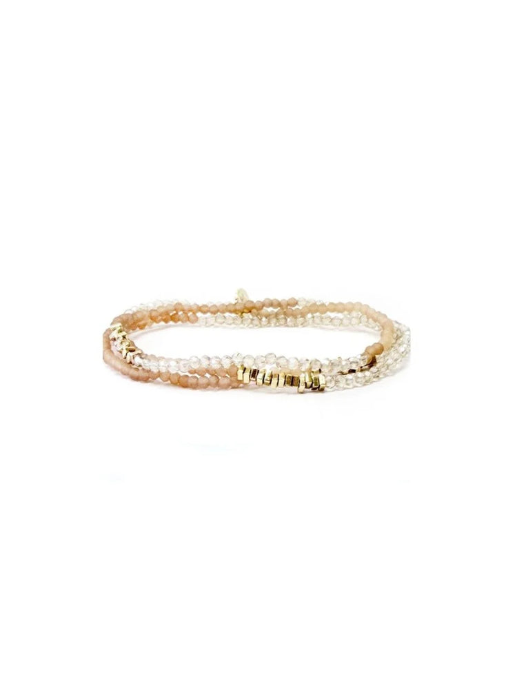 Three-strand wrap bracelet with clear faceted, peachy-pink, and gold bar beads.