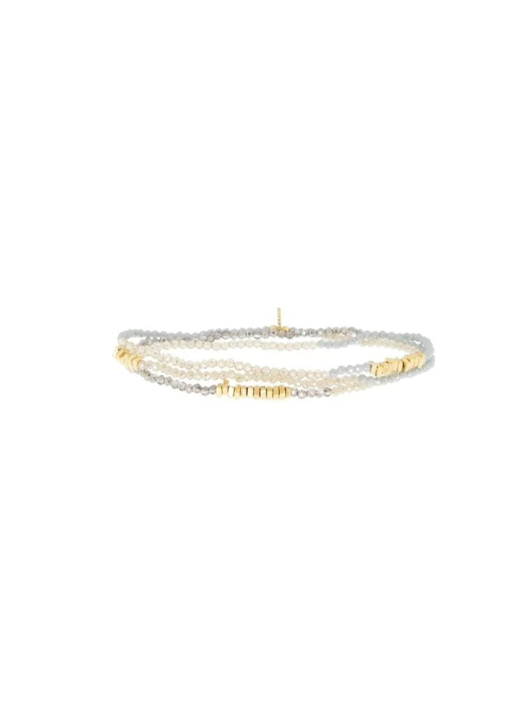 Multi-strand crystal wrap bracelet with light grey and pale cream faceted beads, accented with small gold-toned beads.