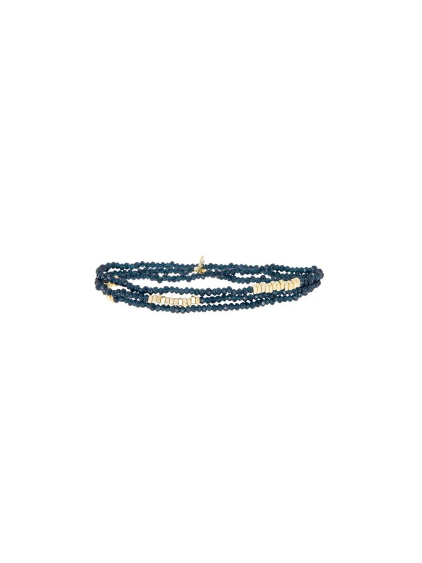 Dark blue crystal wrap bracelet with gold-tone rectangular beads.
