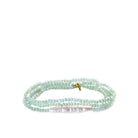 Multi-strand bracelet of small, faceted mint green beads with a central white bar pearl.