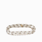 Multi-strand stretch bracelet of small white, beige, & gray faceted beads, with an irregular white pearl & gold clasp.