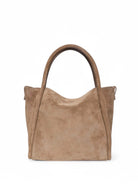 Light brown suede satchel bag with top handles.  Structured, slightly slouchy shape.