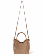 Beige suede satchel bag with  long shoulder strap and top handles; gold-toned hardware.
