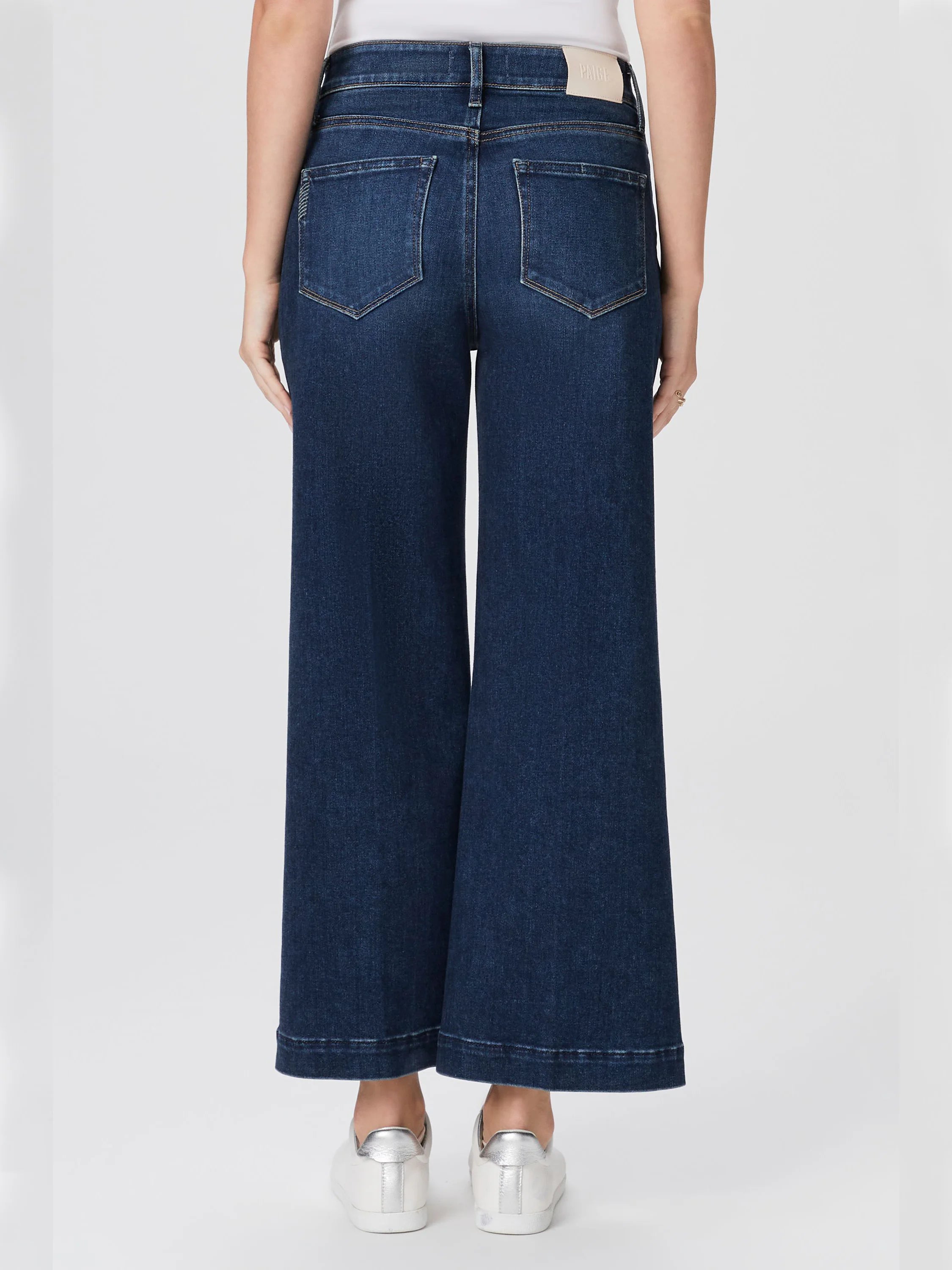 Dark wash, wide-leg jeans; back view.  Features back pockets and a small beige label.